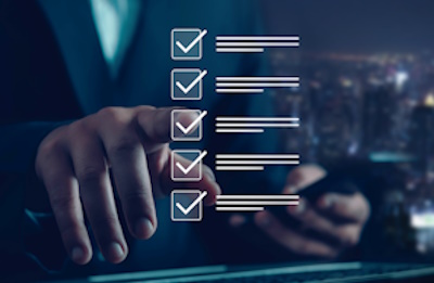 Business professional selecting a checklist item on a digital interface with a cityscape background, symbolizing task completion and efficiency.